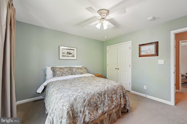 bedroom with baseboards, light carpet, ceiling fan, and a closet