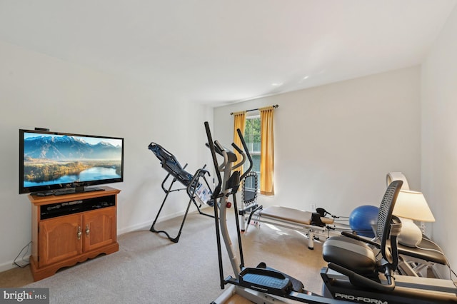 exercise area with light colored carpet and baseboards