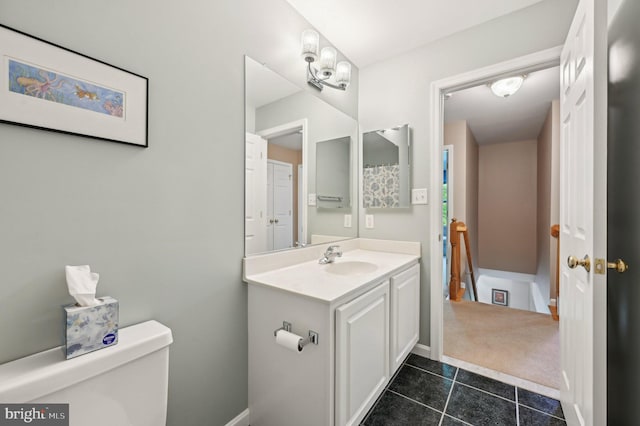 bathroom featuring tile patterned floors, vanity, and toilet