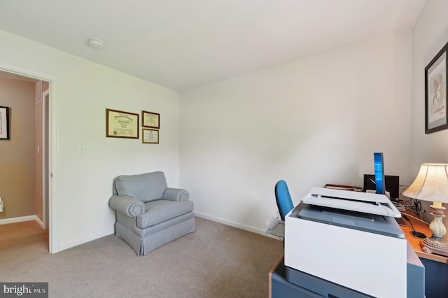 office area featuring light colored carpet and baseboards