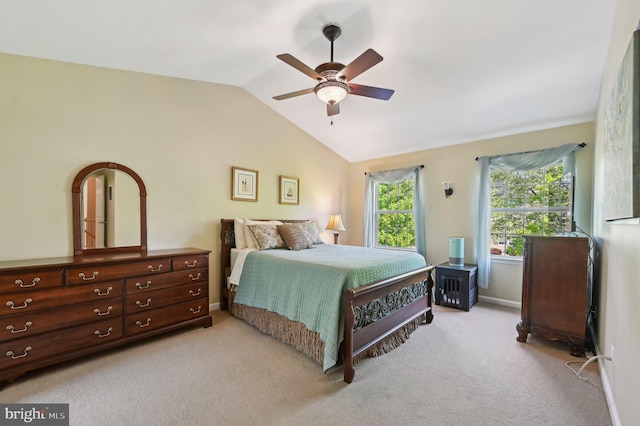 bedroom with ceiling fan, vaulted ceiling, light carpet, and baseboards