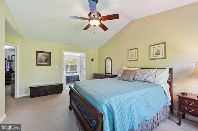 carpeted bedroom featuring baseboards, a ceiling fan, vaulted ceiling, and a spacious closet