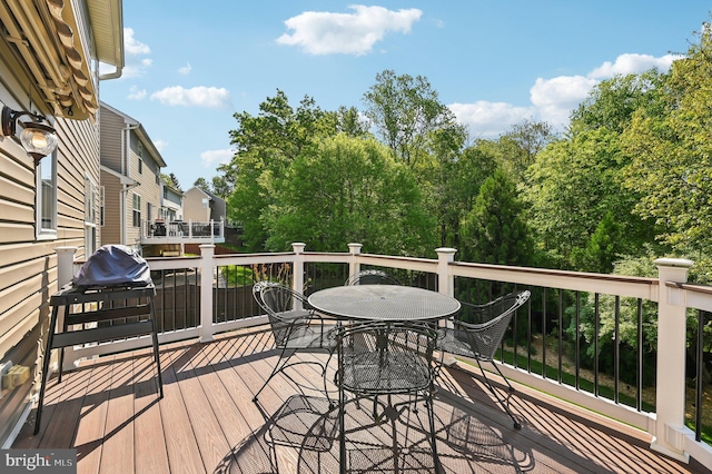 deck with outdoor dining area