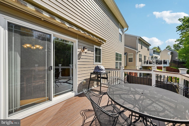 wooden deck featuring a residential view and outdoor dining space