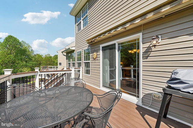 wooden deck featuring outdoor dining area