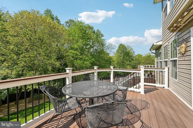 wooden terrace featuring outdoor dining space