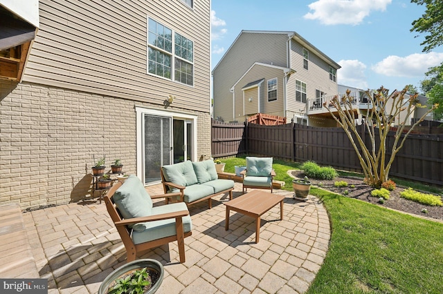 view of patio featuring an outdoor living space and a fenced backyard