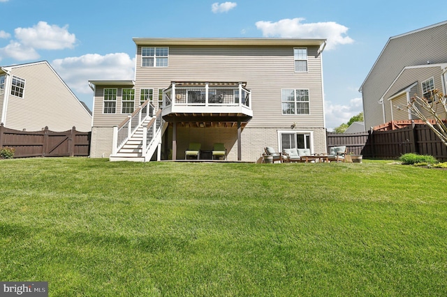 rear view of house with stairs, brick siding, a deck, a fenced backyard, and a yard