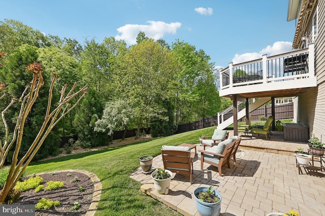 view of yard featuring fence, a deck, a patio area, and stairway