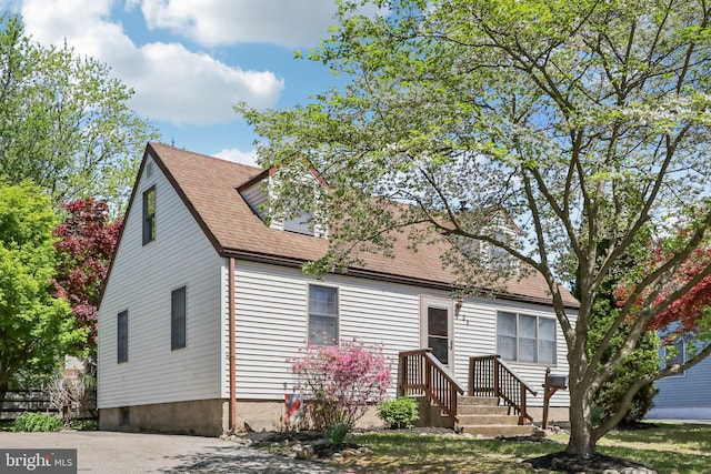 view of front of home featuring roof with shingles