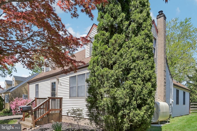 view of side of property with heating fuel