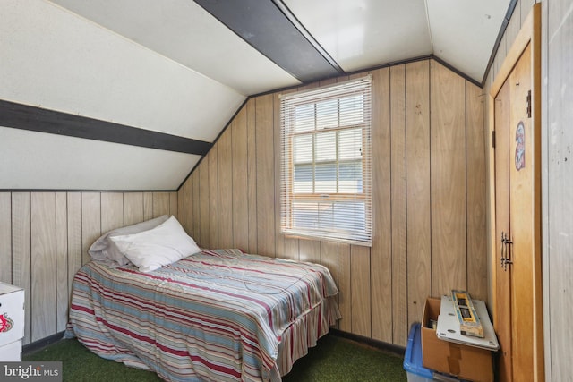 bedroom with dark carpet, lofted ceiling, and wooden walls