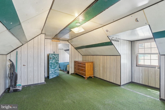 additional living space with carpet flooring, wood walls, and lofted ceiling