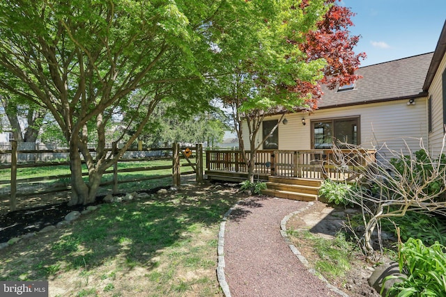 view of yard featuring fence and a wooden deck