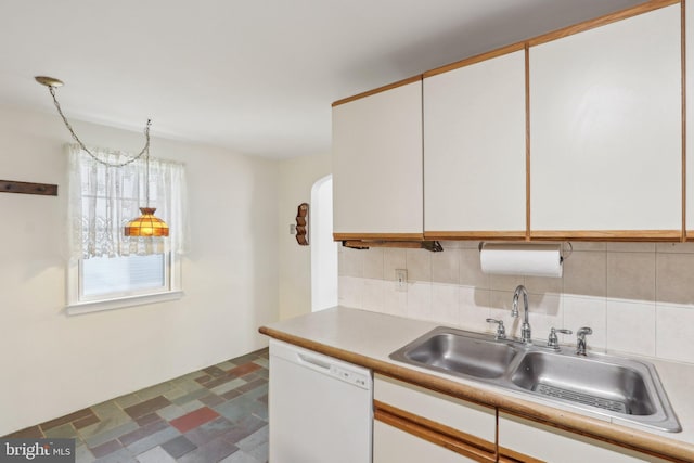 kitchen featuring white cabinetry, decorative backsplash, a sink, and dishwasher