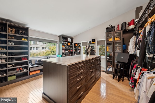 spacious closet with lofted ceiling and light wood-style flooring