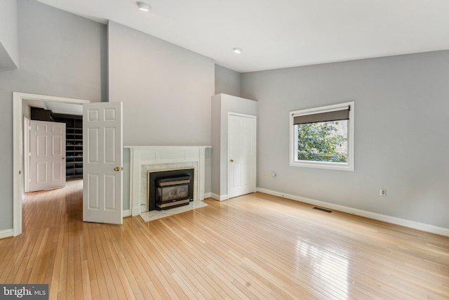 3015 Oregon Knolls Dr NW, Washington, DC 20015 - unfurnished living room with hardwood / wood-style flooring, baseboards, and high vaulted ceiling