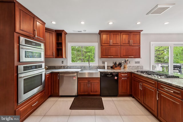 kitchen with a sink, a healthy amount of sunlight, visible vents, and appliances with stainless steel finishes