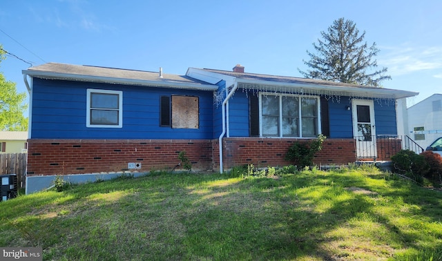 single story home featuring fence, a chimney, a front yard, and brick siding