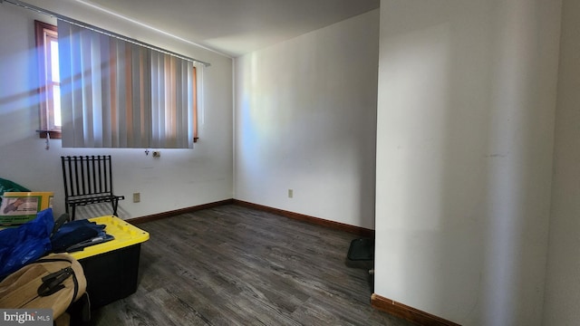 unfurnished bedroom featuring dark wood-type flooring and baseboards