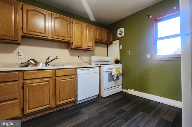 kitchen featuring a sink, light countertops, dark wood-style floors, baseboards, and white appliances