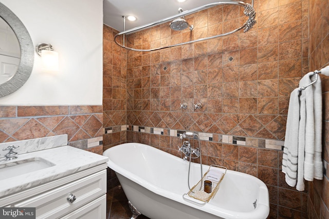 full bath with a freestanding bath, tile walls, vanity, recessed lighting, and tiled shower