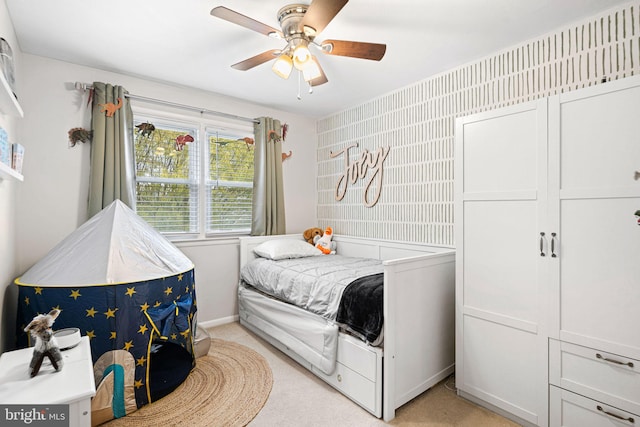 bedroom featuring baseboards, ceiling fan, and light carpet