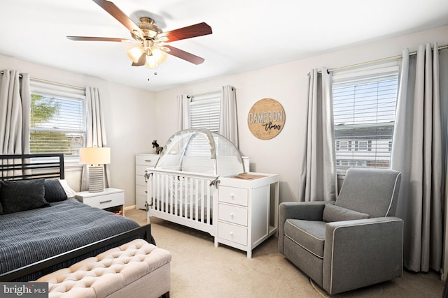 bedroom with light carpet and a ceiling fan