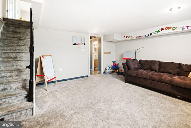 carpeted living area with baseboards and stairway