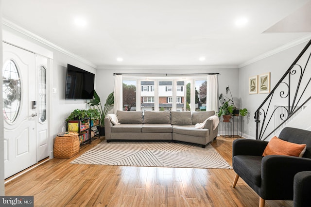 living area with stairway, recessed lighting, crown molding, and light wood finished floors