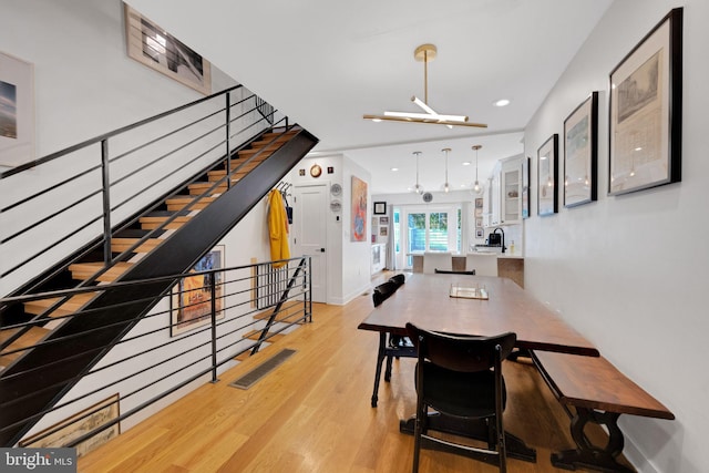 dining room featuring stairs, recessed lighting, baseboards, light wood-type flooring, and visible vents