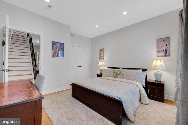 bedroom with recessed lighting, baseboards, visible vents, and wood finished floors