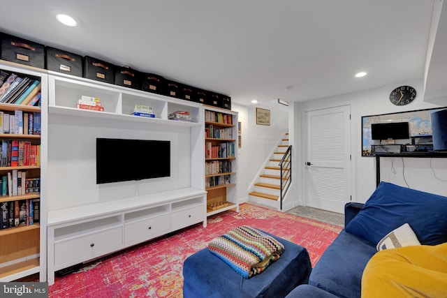 living area with recessed lighting, baseboards, and stairway