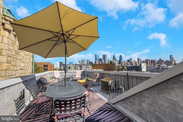 view of patio featuring a view of city and outdoor dining space