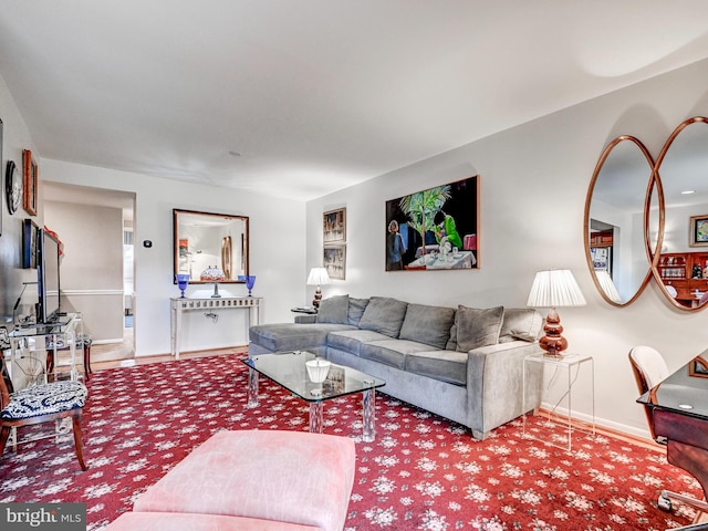 living area featuring carpet floors and baseboards