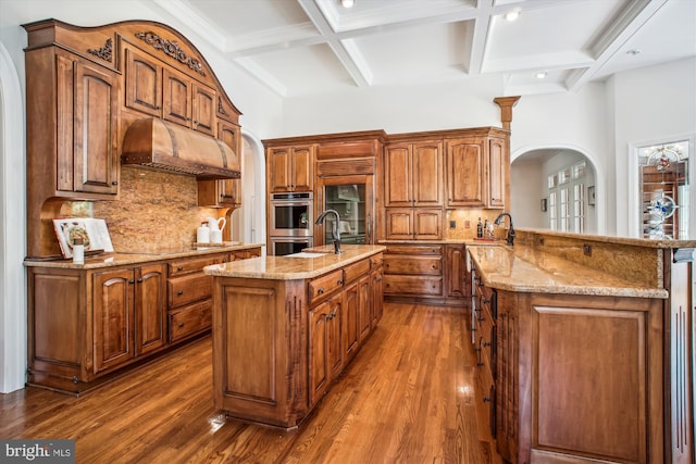 10601 Little Run Farm Ct, Vienna, VA 22182 - kitchen with arched walkways, coffered ceiling, a peninsula, and beam ceiling