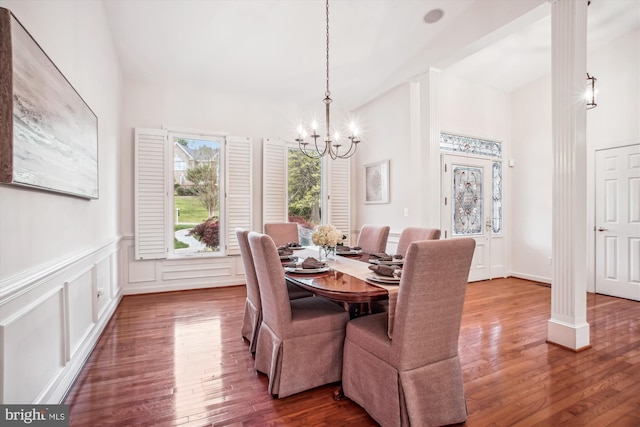 10601 Little Run Farm Ct, Vienna, VA 22182 - dining space with an inviting chandelier, wainscoting, dark wood finished floors, decorative columns, and a towering ceiling