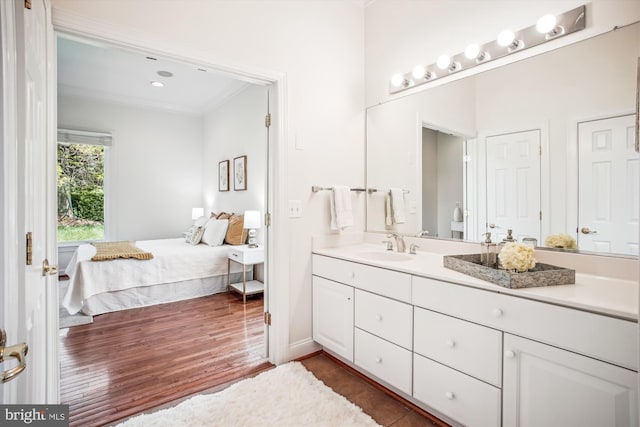 10601 Little Run Farm Ct, Vienna, VA 22182 - ensuite bathroom with crown molding, ensuite bathroom, wood finished floors, and vanity