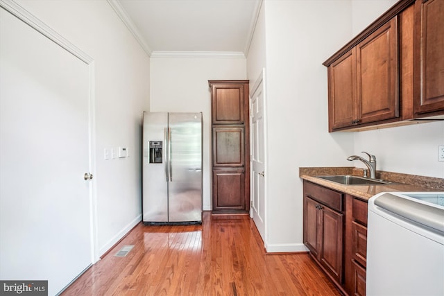 10601 Little Run Farm Ct, Vienna, VA 22182 - kitchen with light wood-type flooring, a sink, baseboards, stainless steel fridge, and ornamental molding