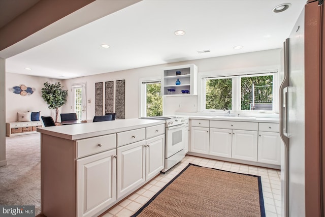 10601 Little Run Farm Ct, Vienna, VA 22182 - kitchen featuring open shelves, a sink, white appliances, white cabinetry, and a peninsula