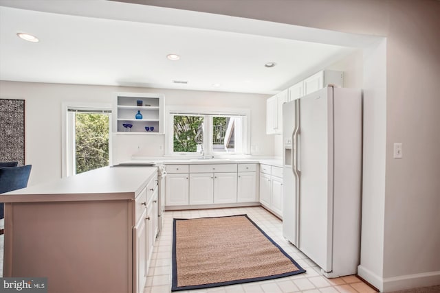10601 Little Run Farm Ct, Vienna, VA 22182 - kitchen with visible vents, open shelves, light countertops, white fridge with ice dispenser, and white cabinetry