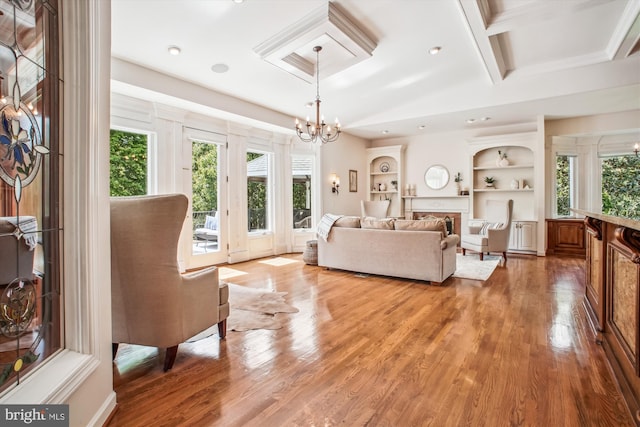 10601 Little Run Farm Ct, Vienna, VA 22182 - living room with light wood finished floors, a notable chandelier, a wealth of natural light, and built in shelves