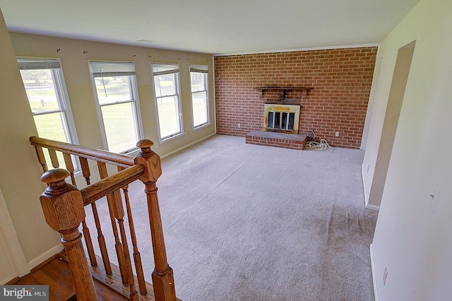 living room featuring a brick fireplace, carpet, and baseboards