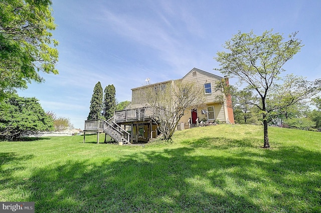back of house featuring stairs, a wooden deck, and a yard