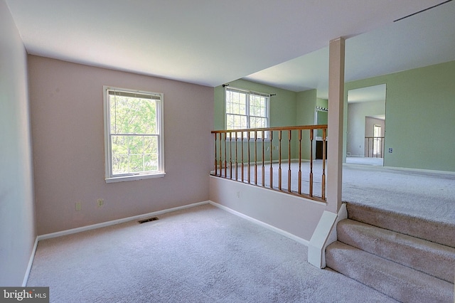empty room featuring carpet floors and baseboards