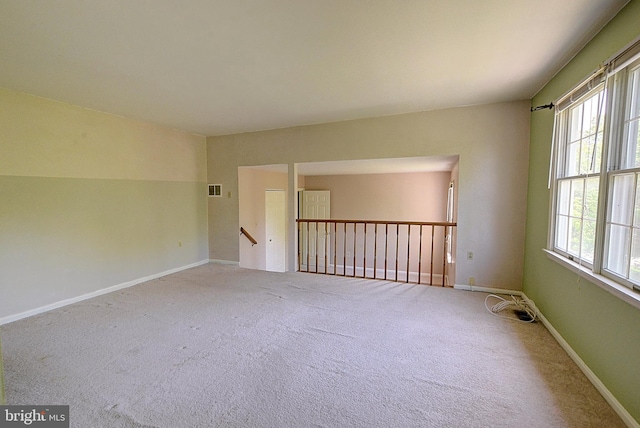 carpeted spare room with baseboards