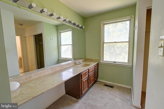 bathroom featuring vanity and baseboards