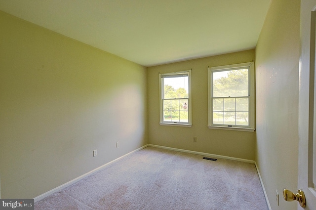 unfurnished room with baseboards and carpet floors