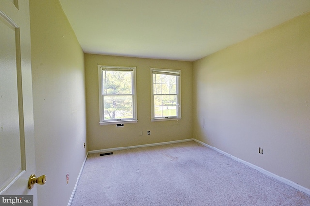 unfurnished room featuring carpet flooring and baseboards
