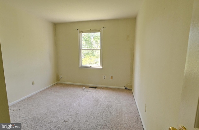spare room with carpet floors and baseboards